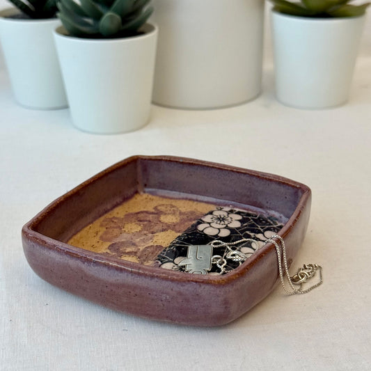 Ceramic tray with floral patterns on a white surface