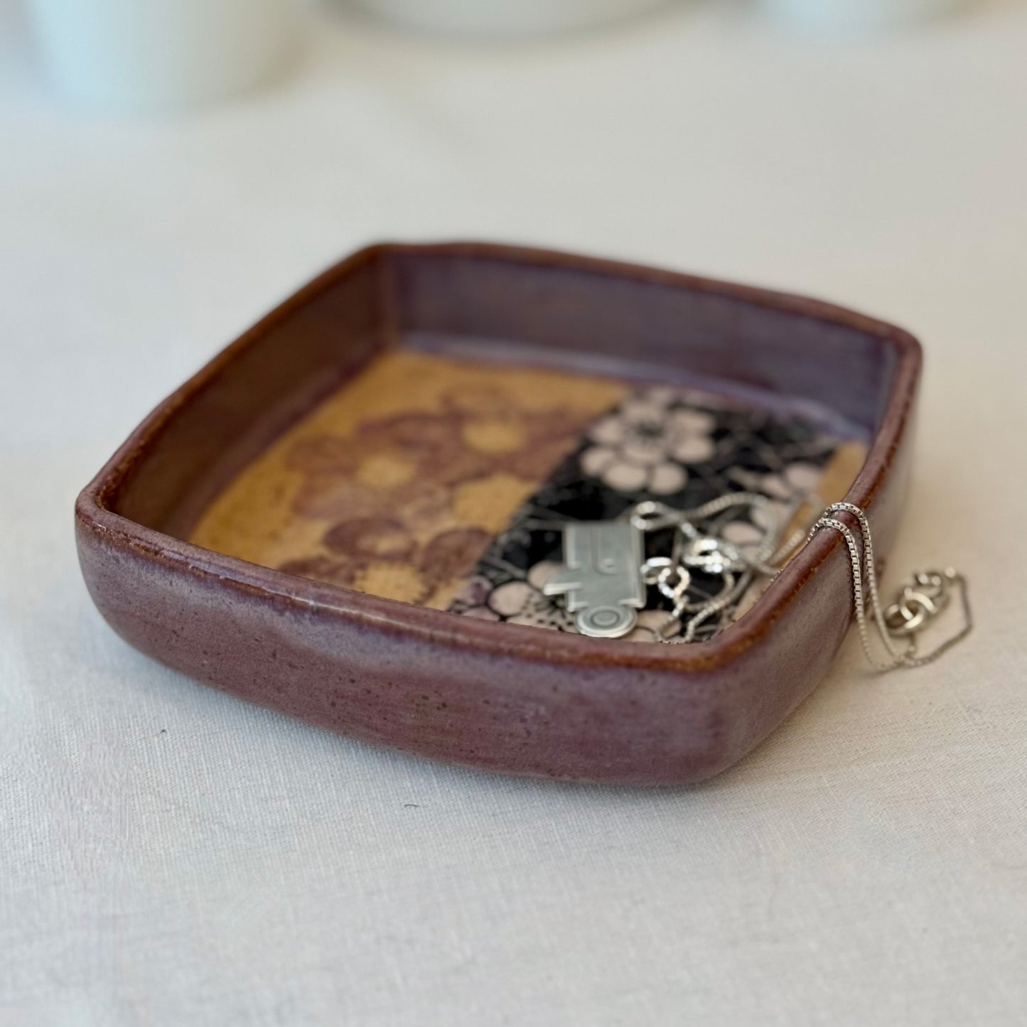 Ceramic tray with floral patterns on a white surface