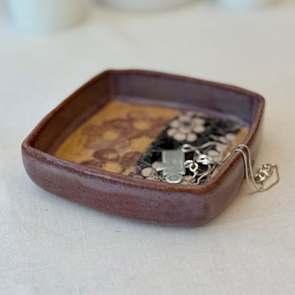 Ceramic tray with floral patterns on a white surface