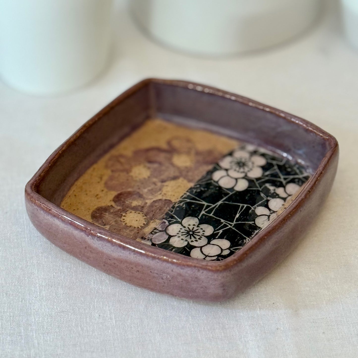 Ceramic tray with floral patterns on a white surface