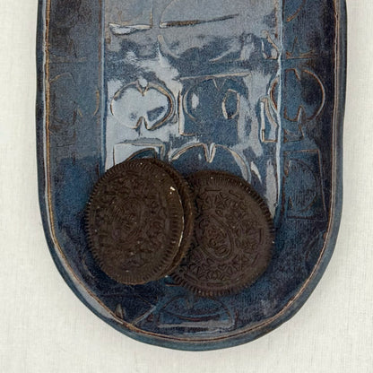 ceramic tray with mid century texture with a couple of oreo cookies