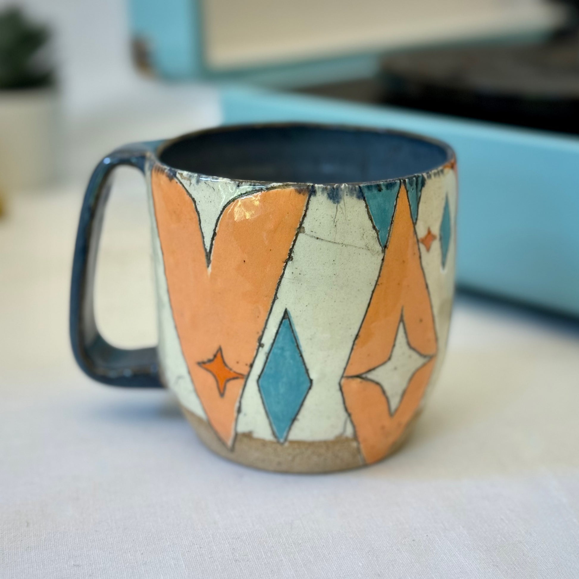 Stoneware mug featuring black cat and retro coffee pot in orange and blue