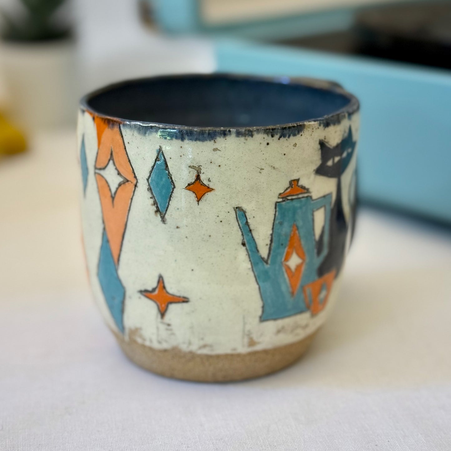 Stoneware mug featuring black cat and retro coffee pot in orange and blue