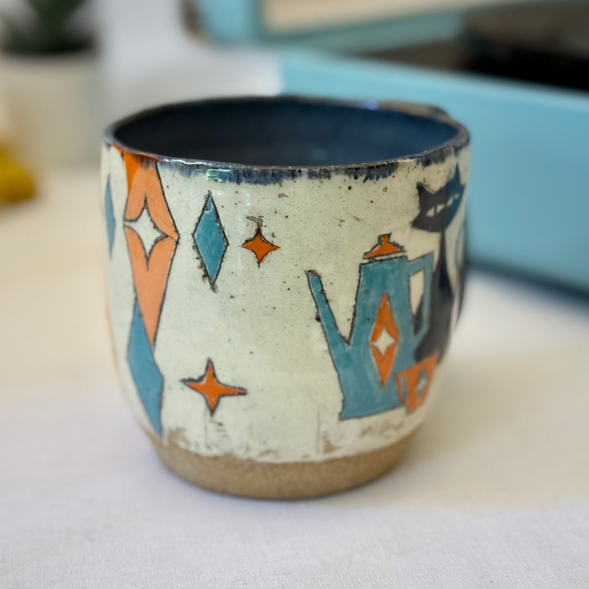 Stoneware mug featuring black cat and retro coffee pot in orange and blue