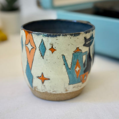 Stoneware mug featuring black cat and retro coffee pot in orange and blue