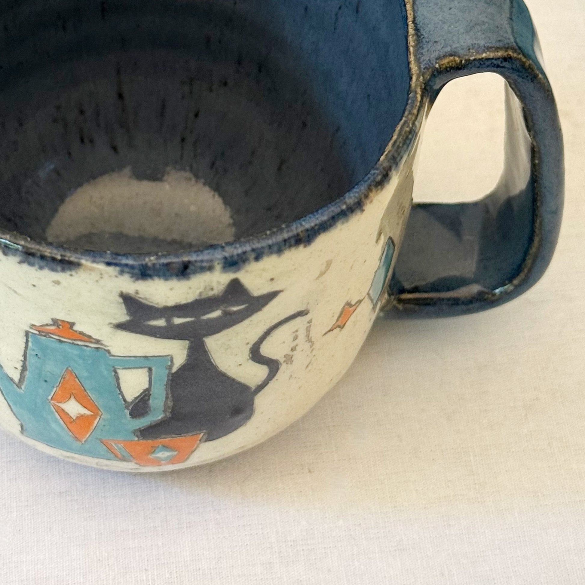 Stoneware mug featuring black cat and retro coffee pot in orange and blue