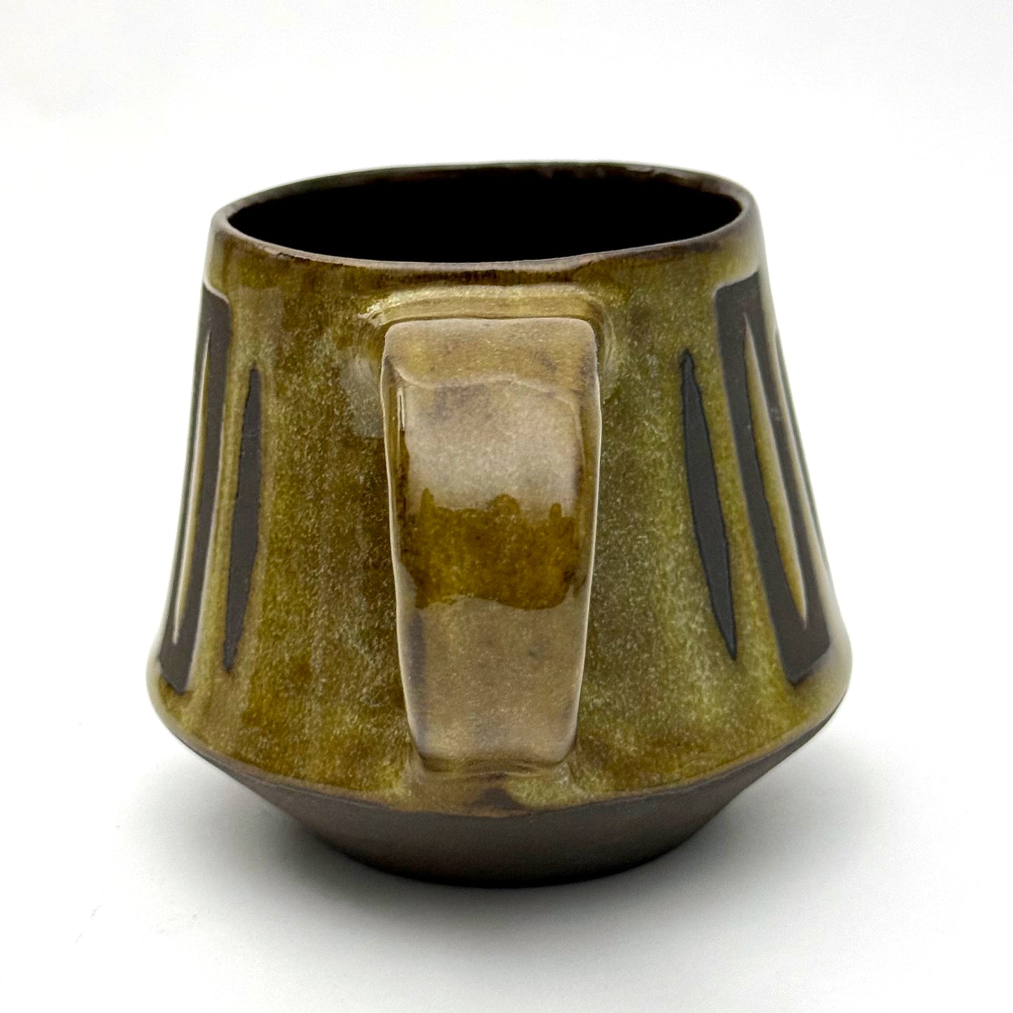 Handmade ceramic mug with a bold mid-century–inspired vertical tape-resist pattern.