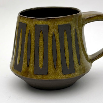 Handmade ceramic mug with a bold mid-century–inspired vertical tape-resist pattern.