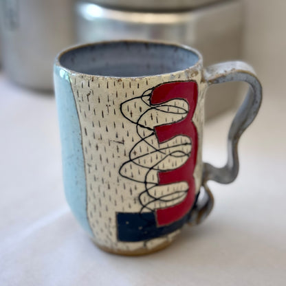Ceramic mug with abstract design on a white surface