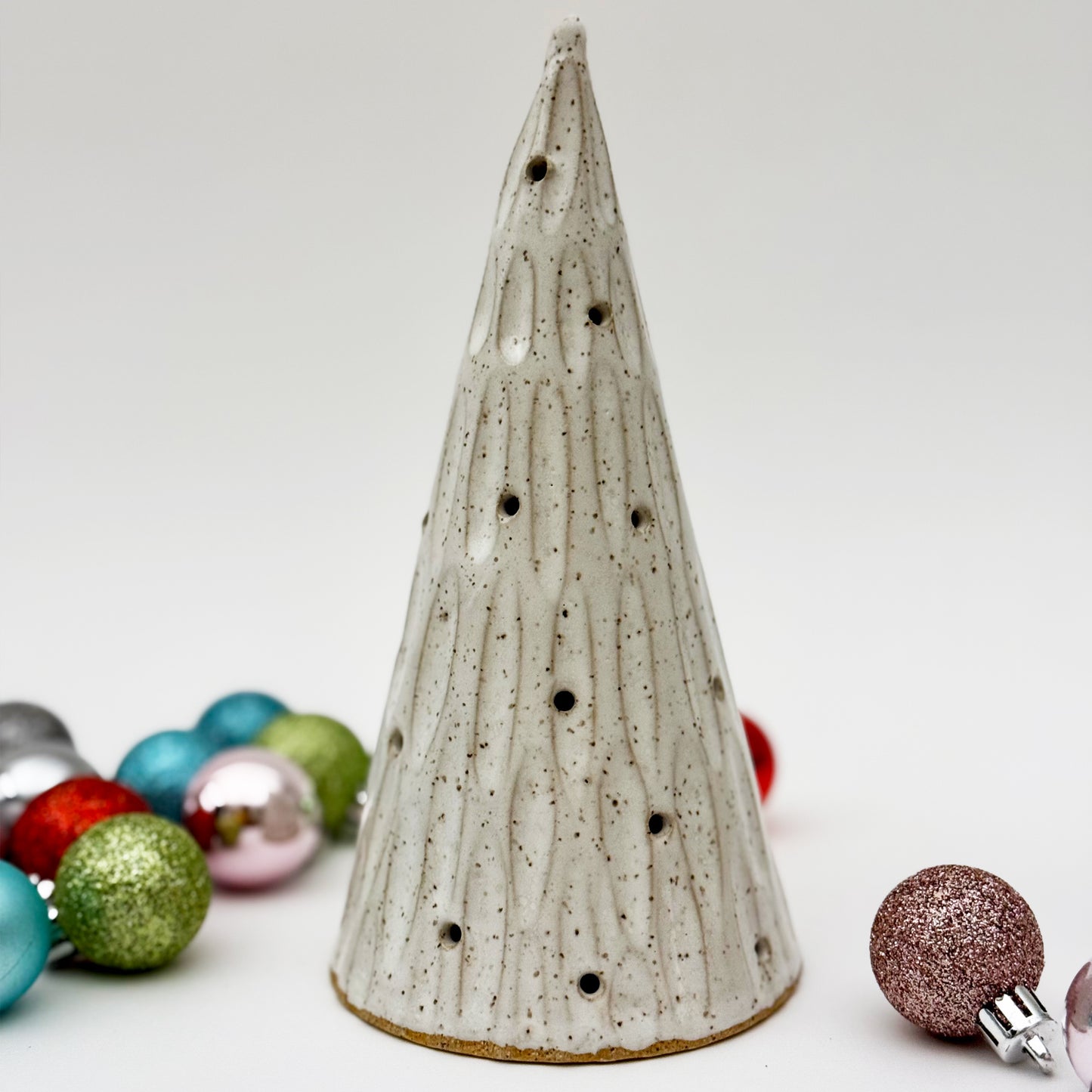 Ceramic Christmas tree with decorative ornaments on a white background