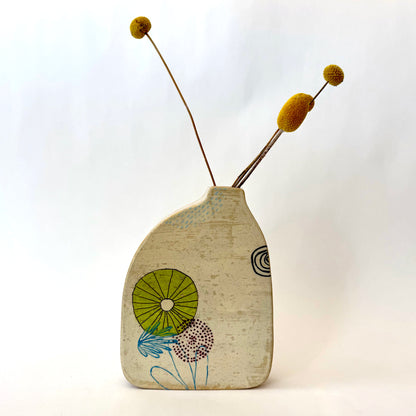 Handmade ceramic vase with a rounded form, featuring two different hand-drawn illustrated designs on opposite sides, photographed on a neutral background.