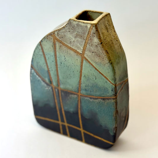 Handmade stoneware vase with cream, green, and brown glaze and clean tape-resist lines.
