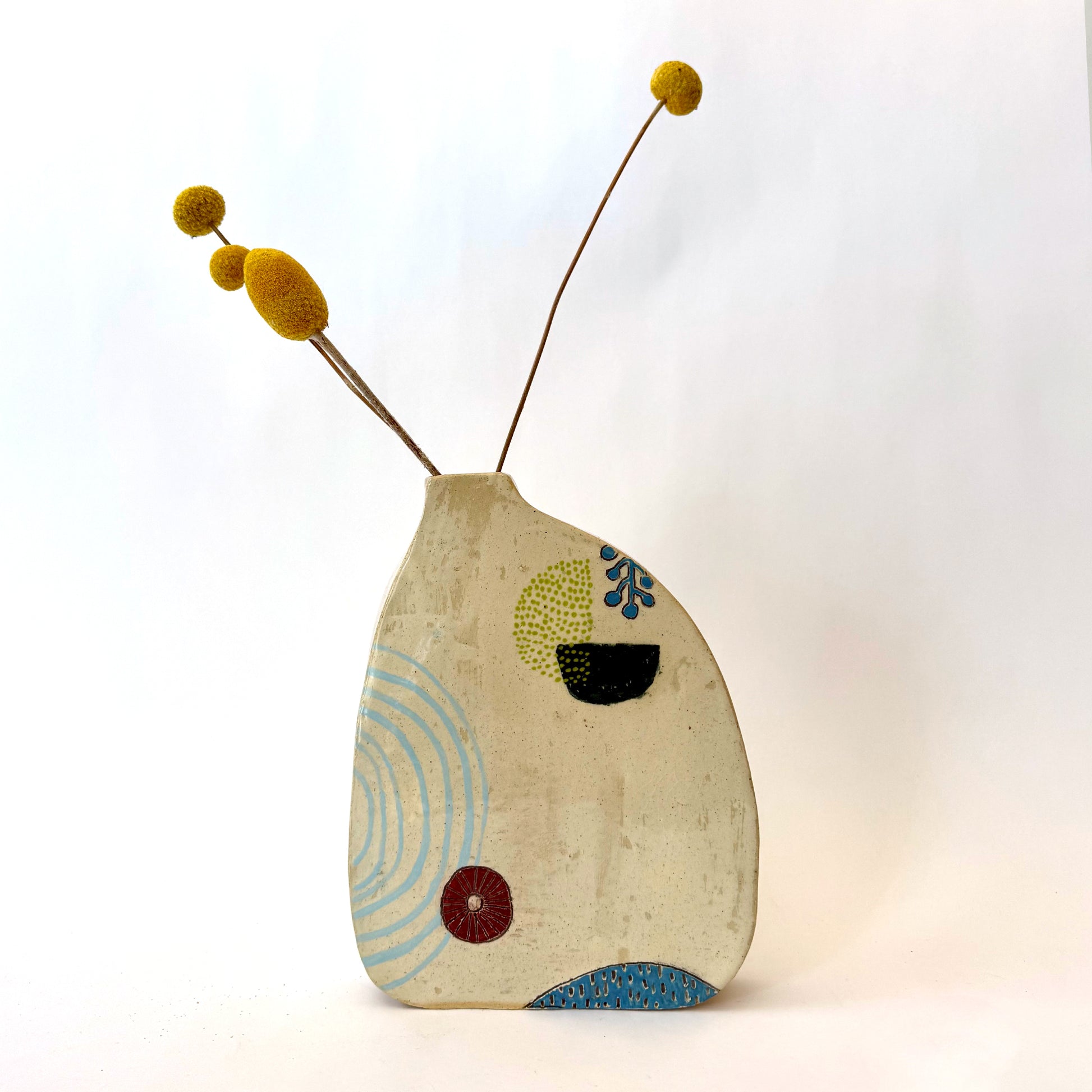 Handmade ceramic vase with a rounded form, featuring two different hand-drawn illustrated designs on opposite sides, photographed on a neutral background.