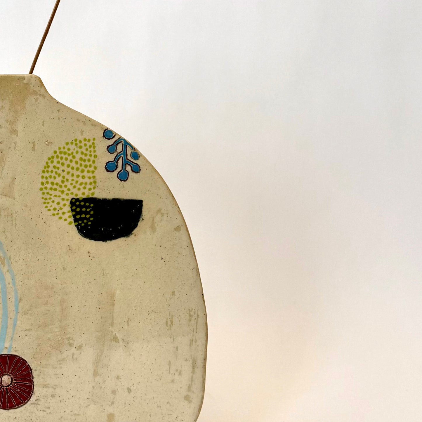 Handmade ceramic vase with a rounded form, featuring two different hand-drawn illustrated designs on opposite sides, photographed on a neutral background.