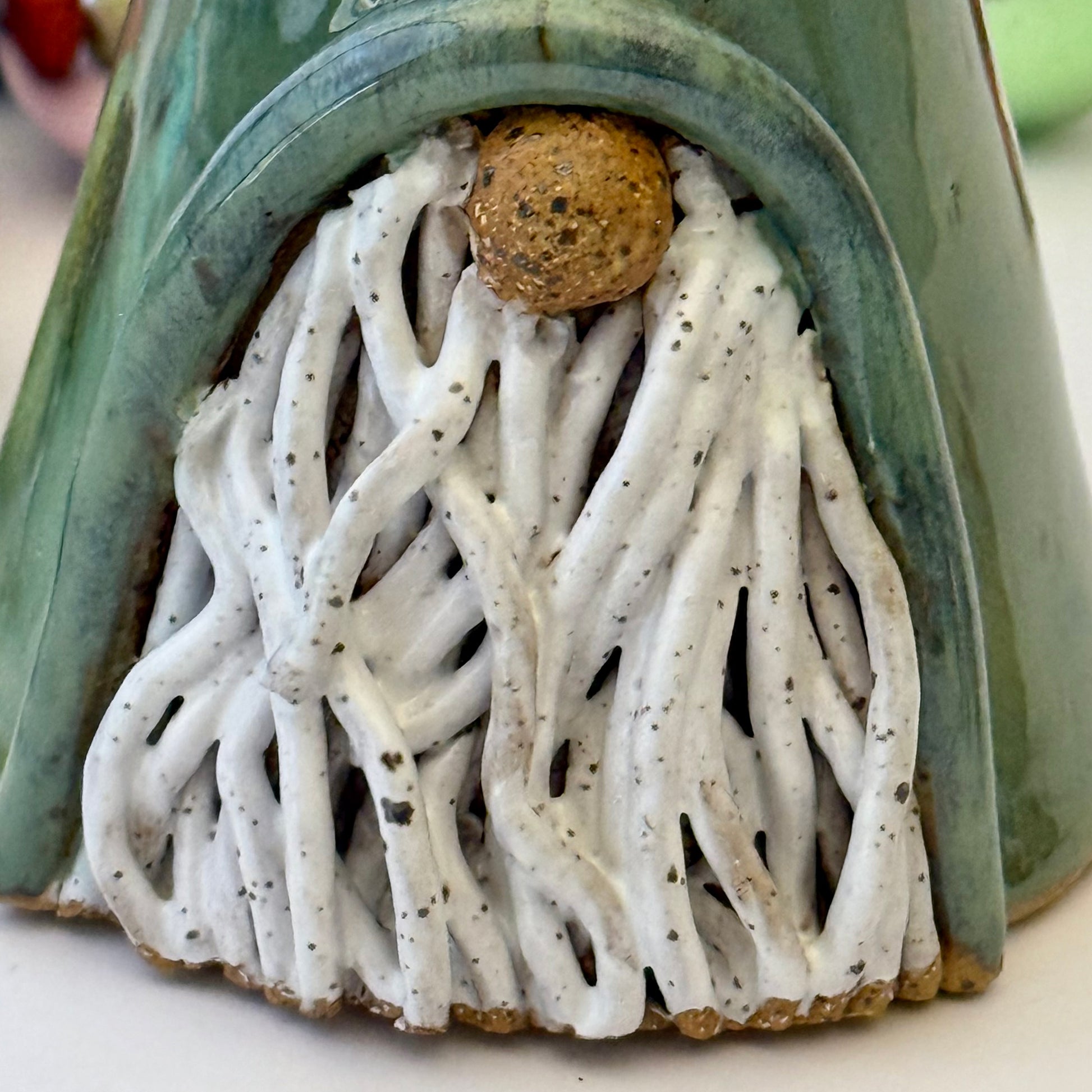 close-up of green ceramic gnome 