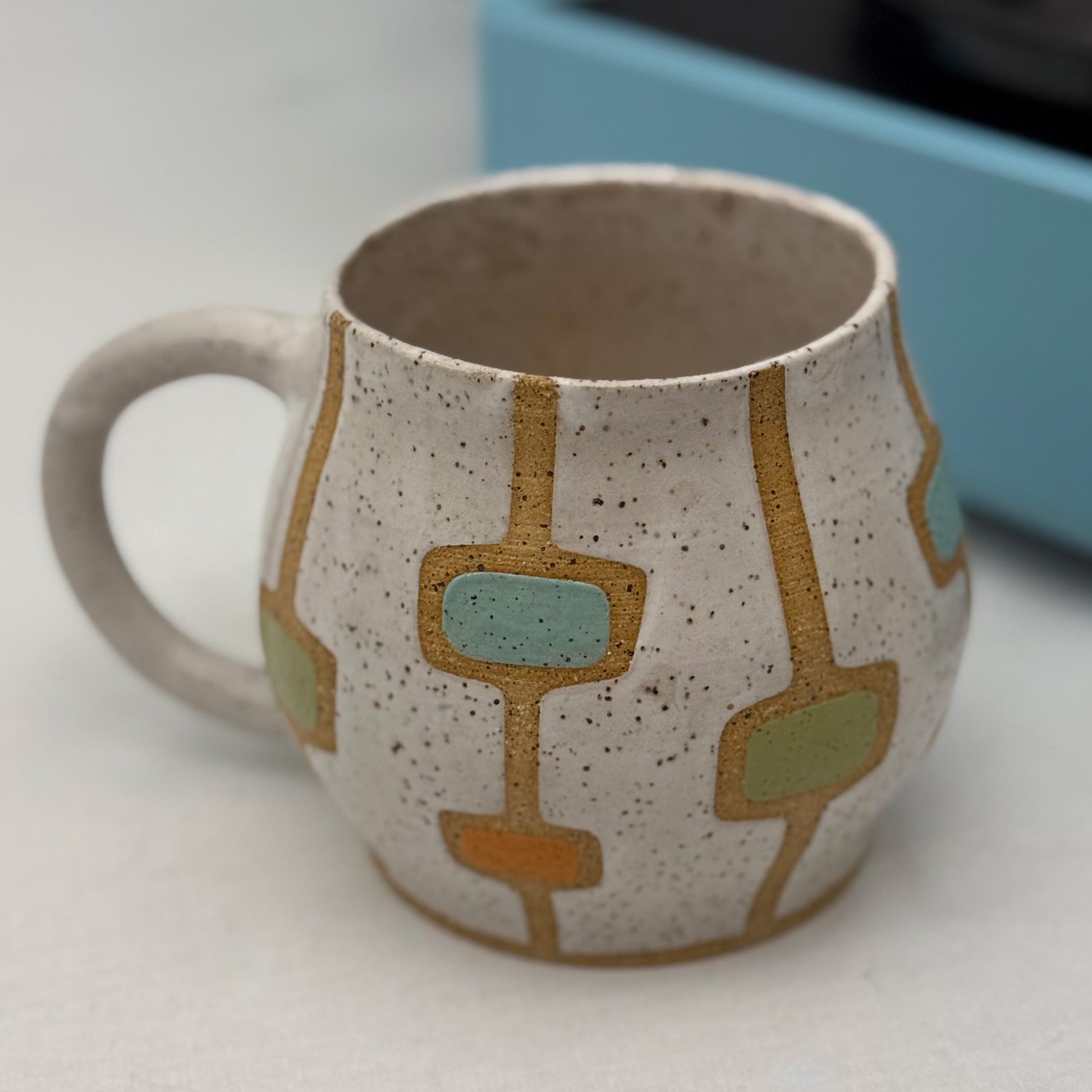 Ceramic mug with geometric design on a white surface