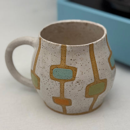 Ceramic mug with geometric design on a white surface