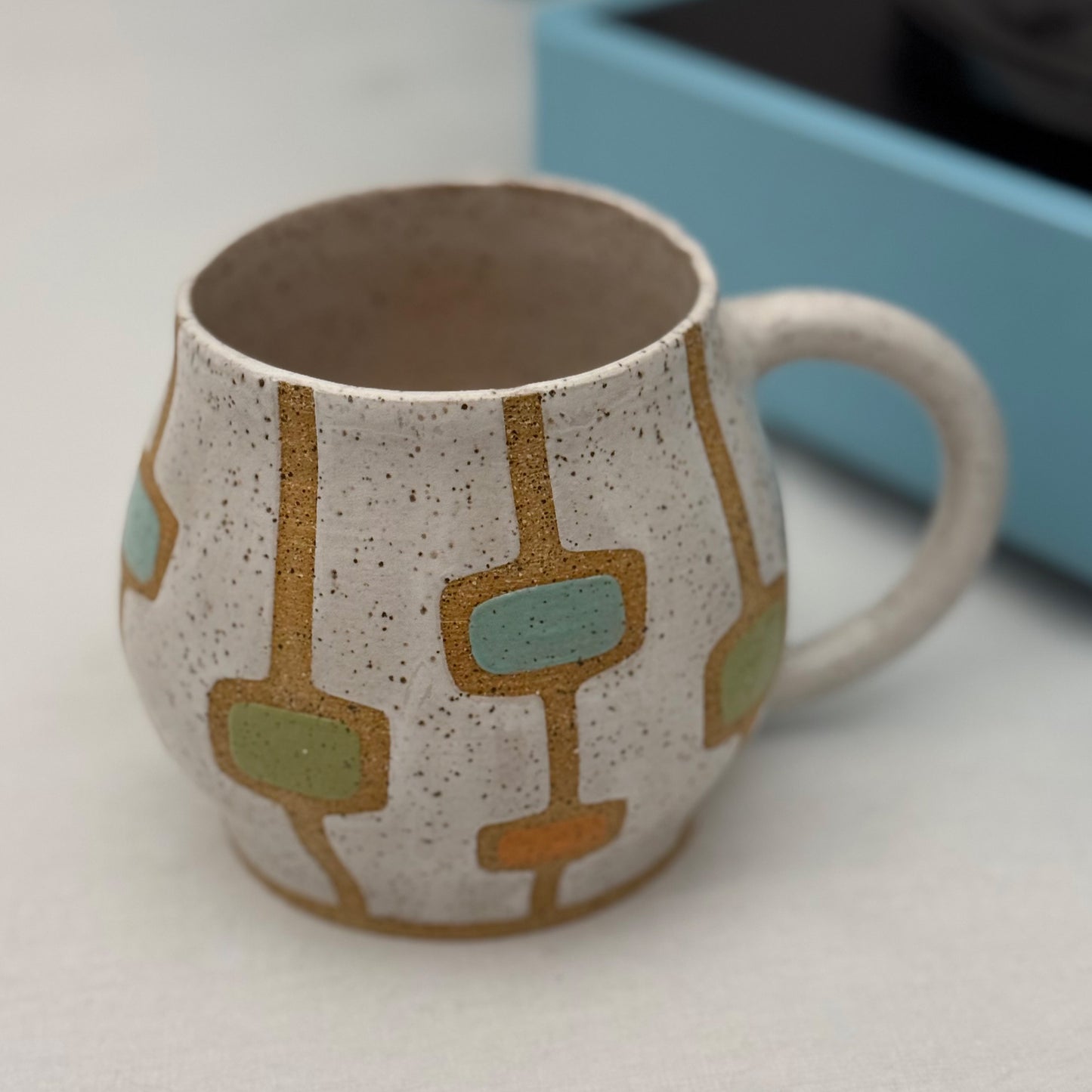 Ceramic mug with geometric pattern on a white surface