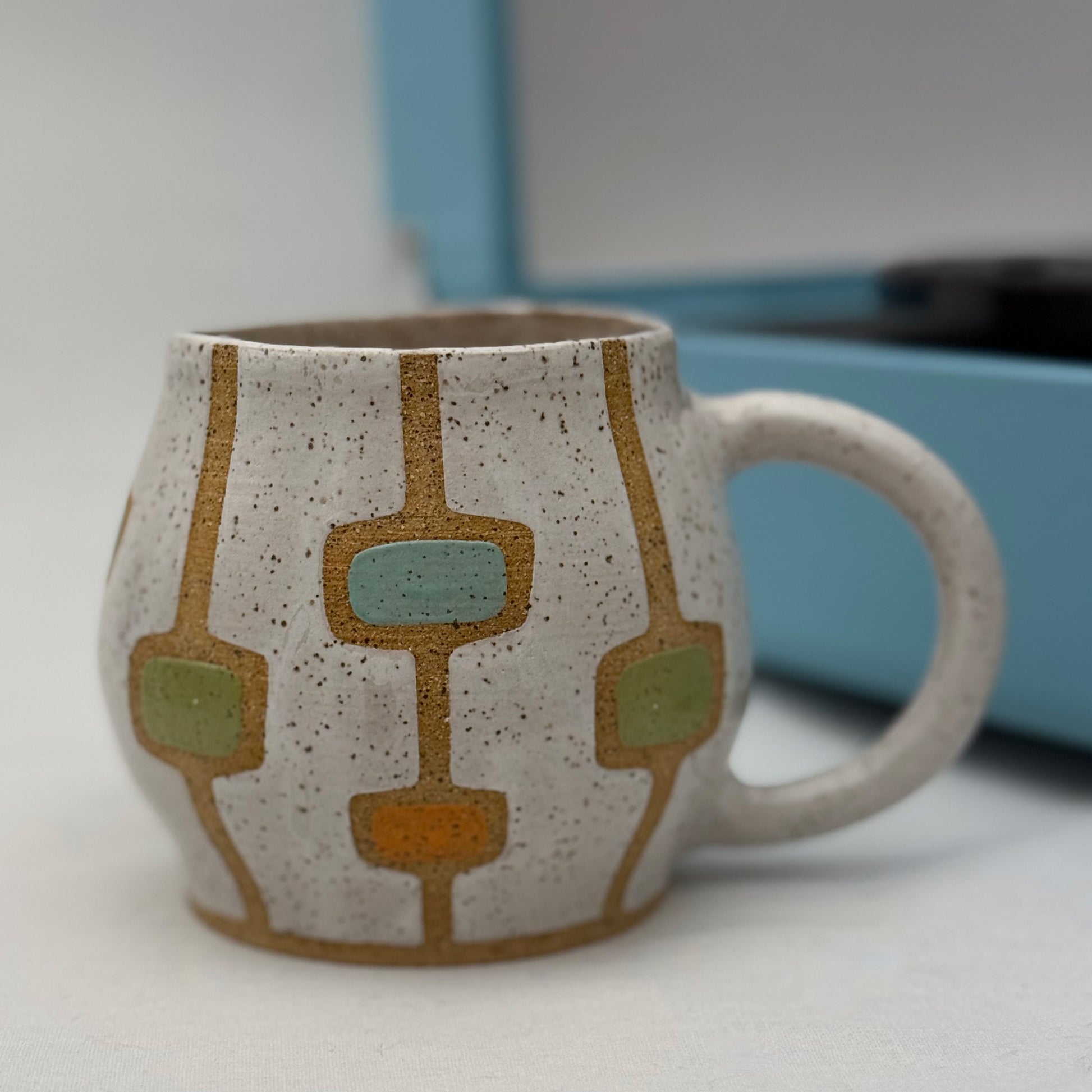 Ceramic mug with geometric pattern on a white surface