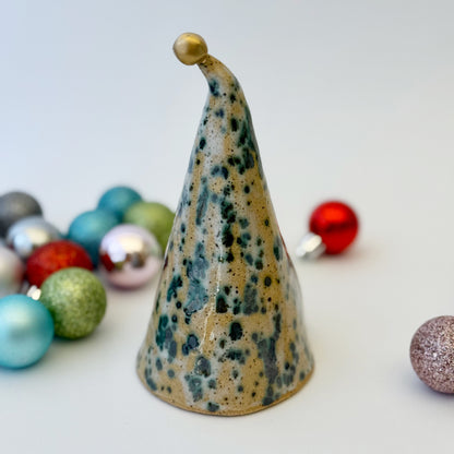 back view of Decorative ceramic gnome figure surrounded by colorful ornaments on a light background