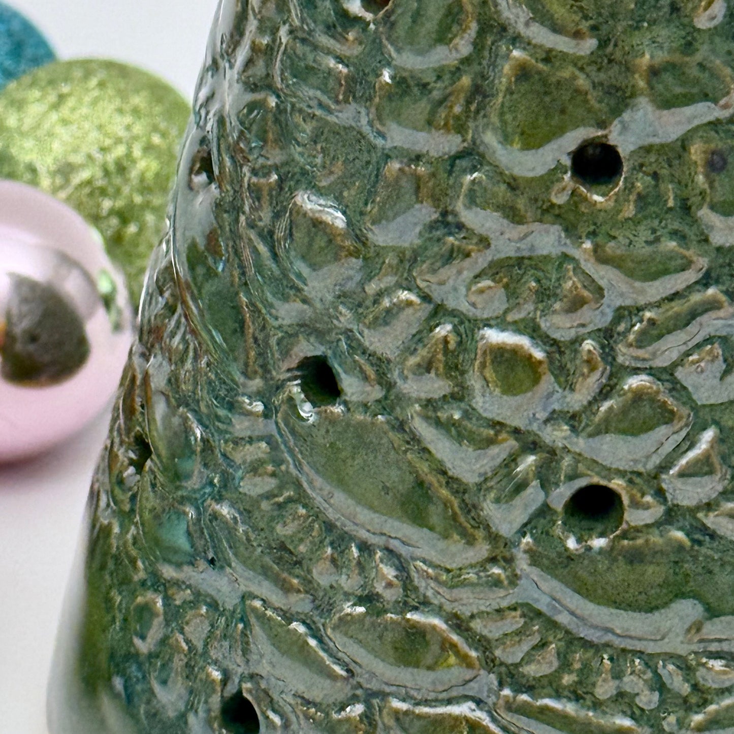 Close-up of a textured ceramic green tree luminary