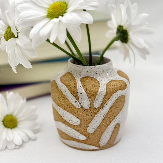 Decorative vase with white floral pattern on a white background