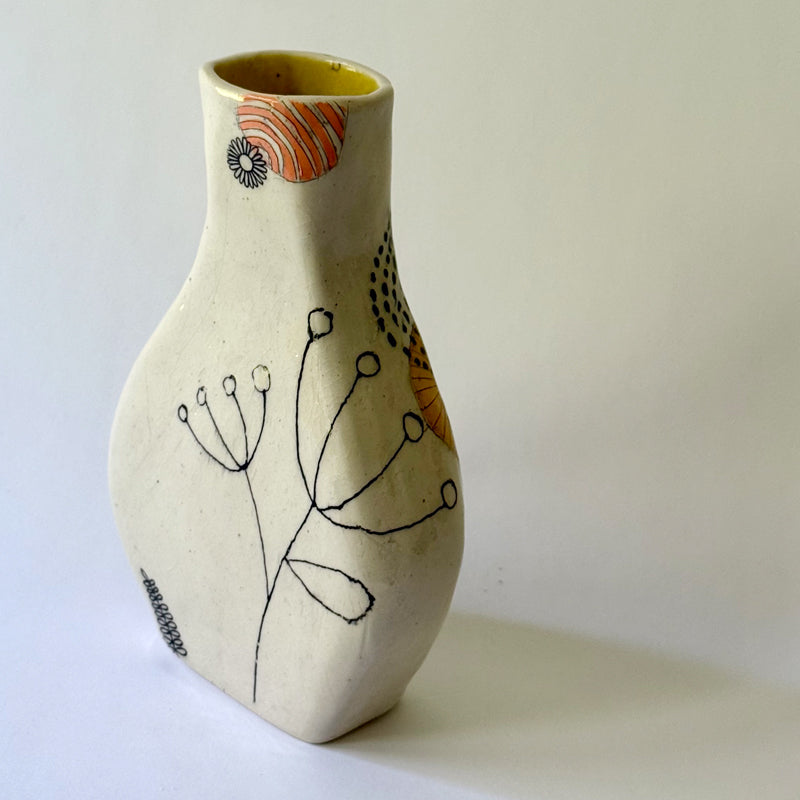 Handbuilt speckled stoneware vase with colorful mid-century-inspired monoprints featuring graphic florals, dotted orbits, and botanical motifs, finished in a glossy clear glaze.