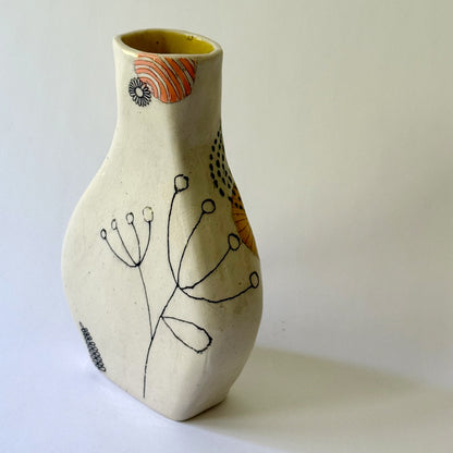 Handbuilt speckled stoneware vase with colorful mid-century-inspired monoprints featuring graphic florals, dotted orbits, and botanical motifs, finished in a glossy clear glaze.