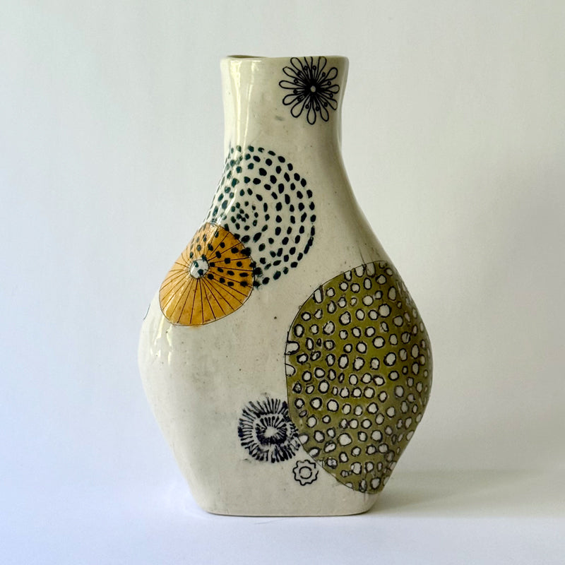 Handbuilt speckled stoneware vase with colorful mid-century-inspired monoprints featuring graphic florals, dotted orbits, and botanical motifs, finished in a glossy clear glaze.