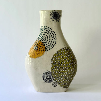 Handbuilt speckled stoneware vase with colorful mid-century-inspired monoprints featuring graphic florals, dotted orbits, and botanical motifs, finished in a glossy clear glaze.