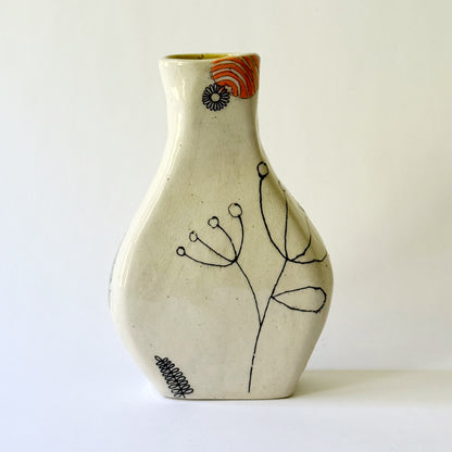 Handbuilt speckled stoneware vase with colorful mid-century-inspired monoprints featuring graphic florals, dotted orbits, and botanical motifs, finished in a glossy clear glaze.