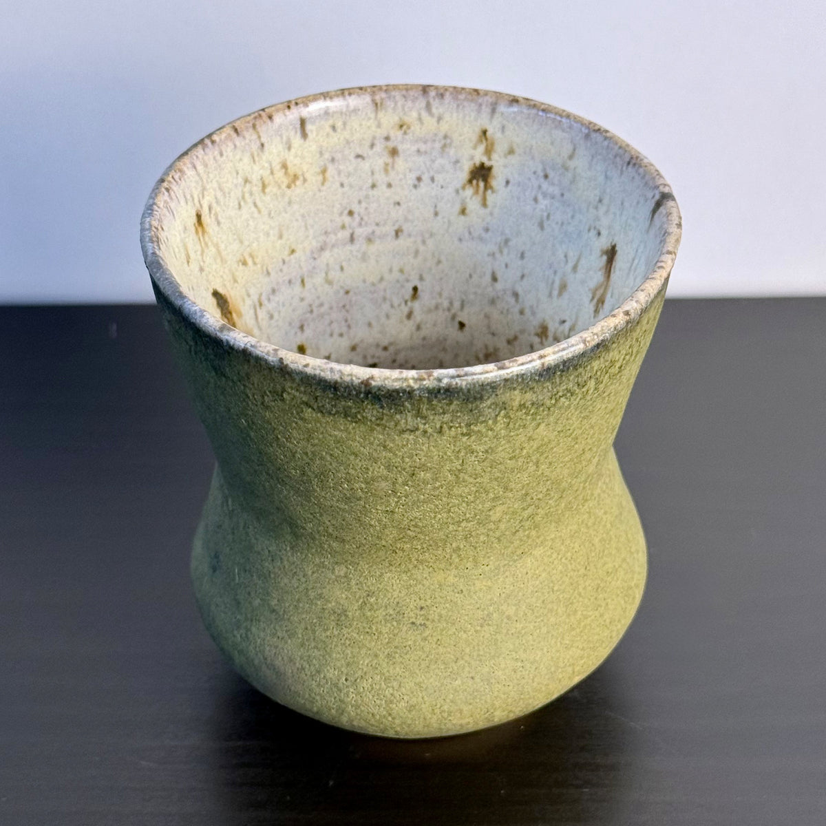 Handmade Olive Cinch Vase with a softly pinched hourglass silhouette, rounded lower body, and matte olive-green glaze with subtle darker variation near the rim and sides.