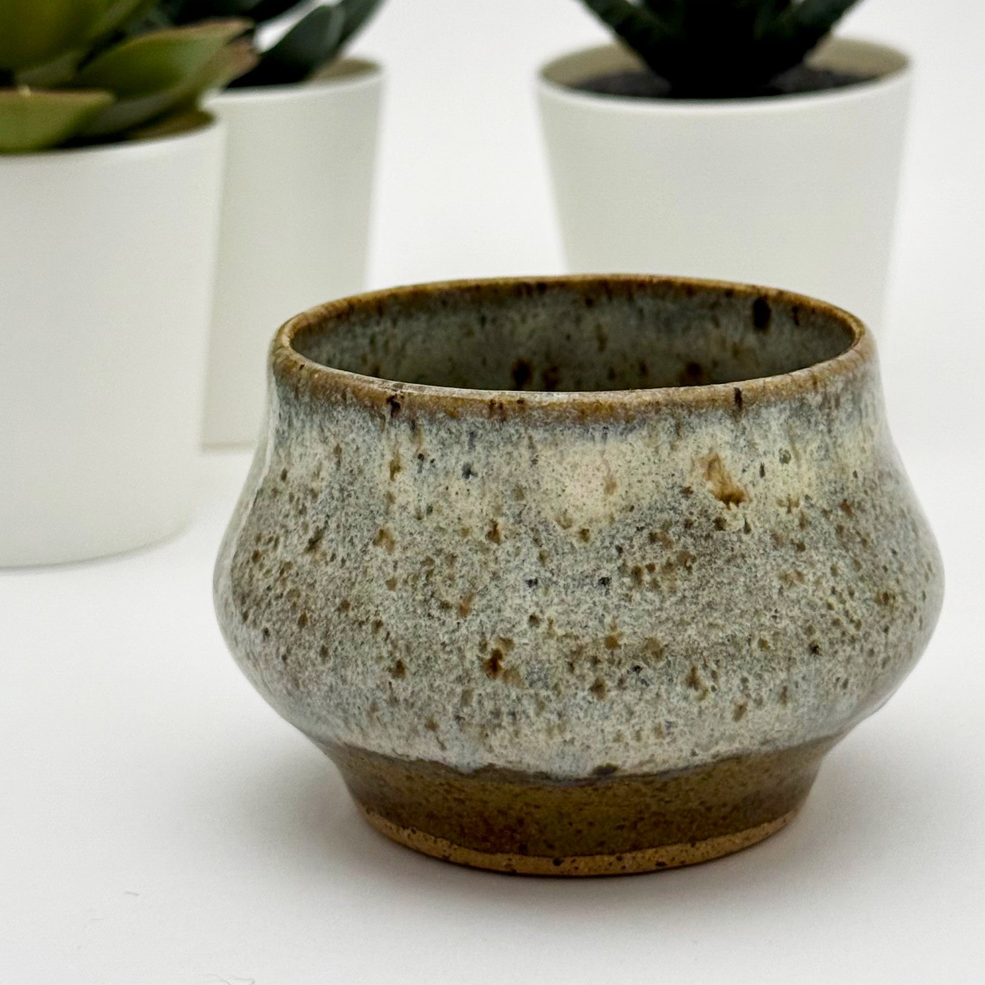 Ceramic pot with a textured surface on a white background