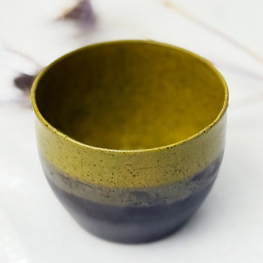 Rounded handmade ceramic pot featuring an olive green exterior and dark walnut glaze inside.
