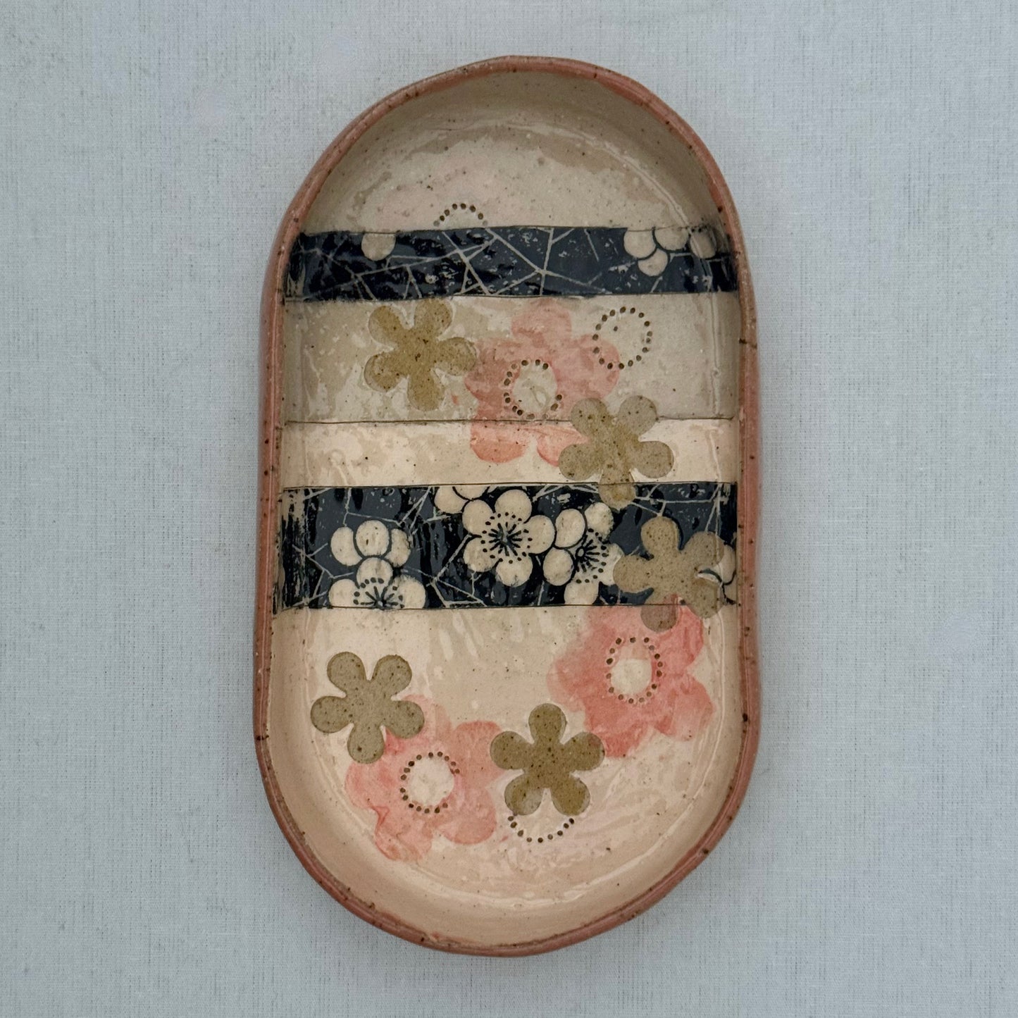 Decorative ceramic tray with floral patterns on a white background