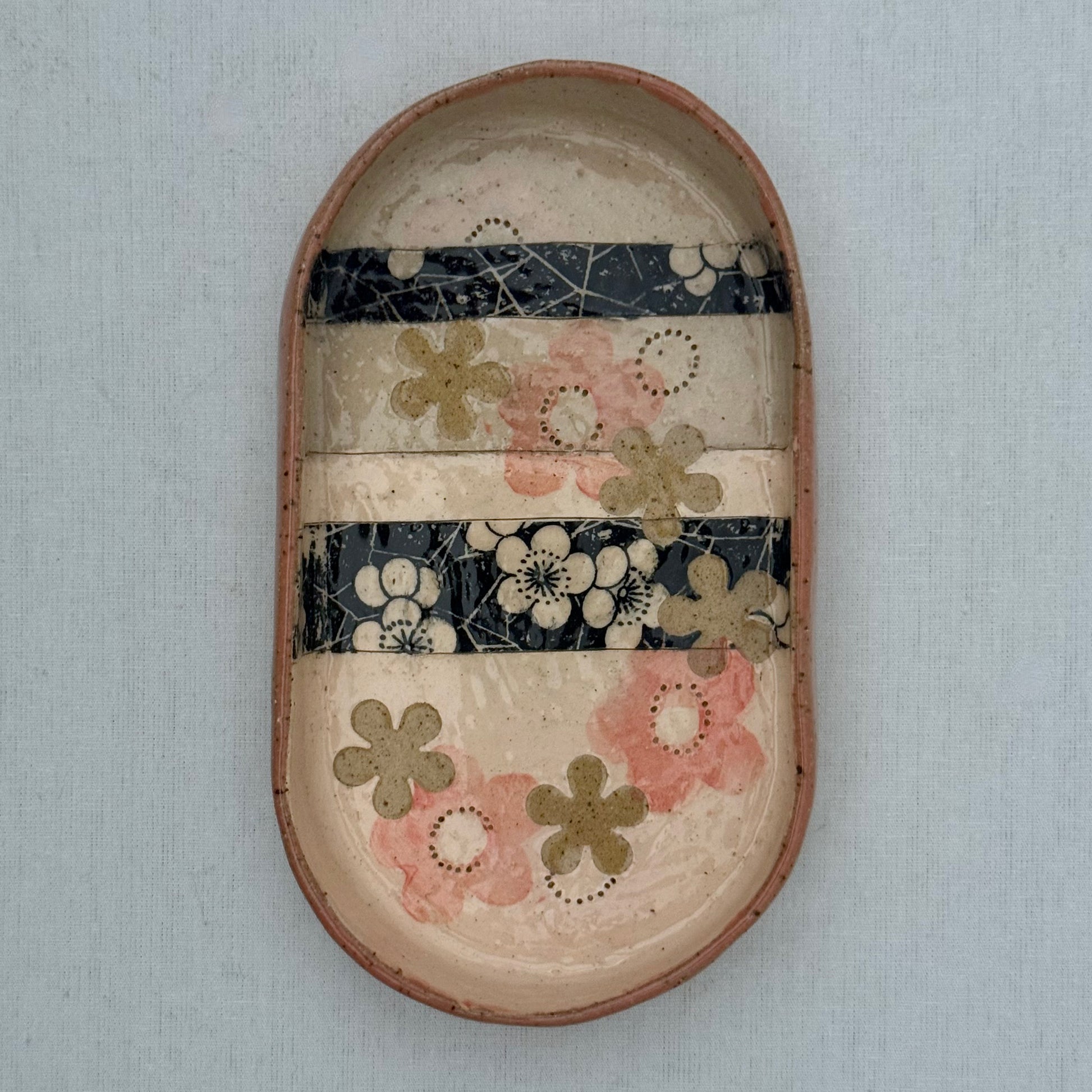 Decorative ceramic tray with floral patterns on a white background