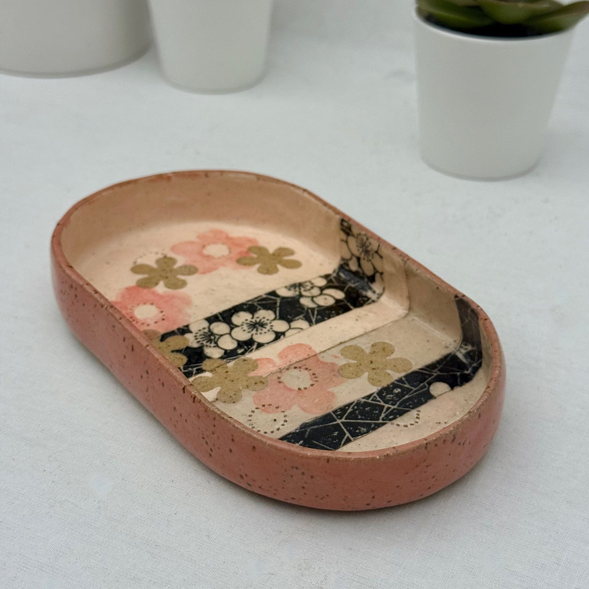 Ceramic tray with floral patterns on a white surface