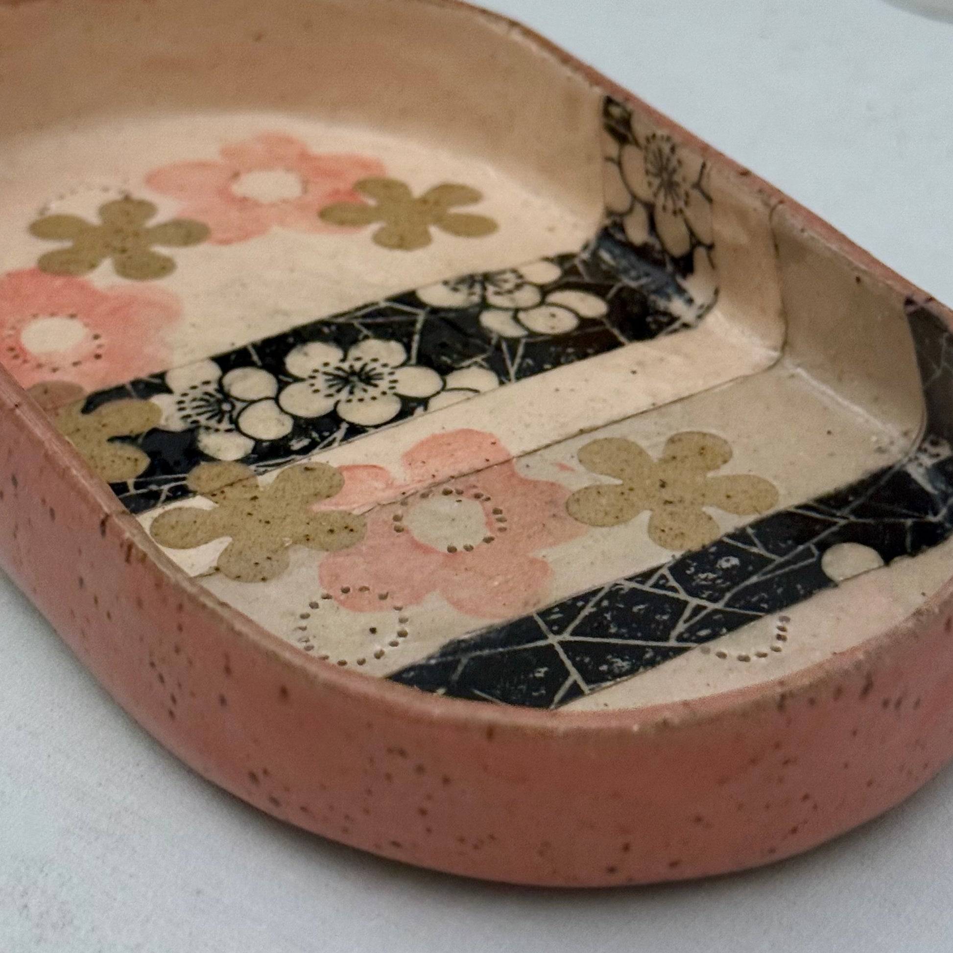 Decorative ceramic tray with floral patterns on a white background