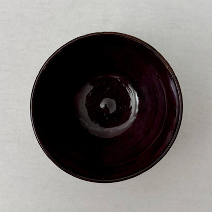 Purple ceramic bowl on a white background