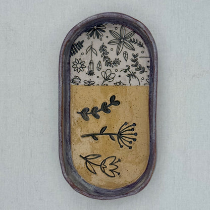 Decorative ceramic tray with floral patterns on a light background