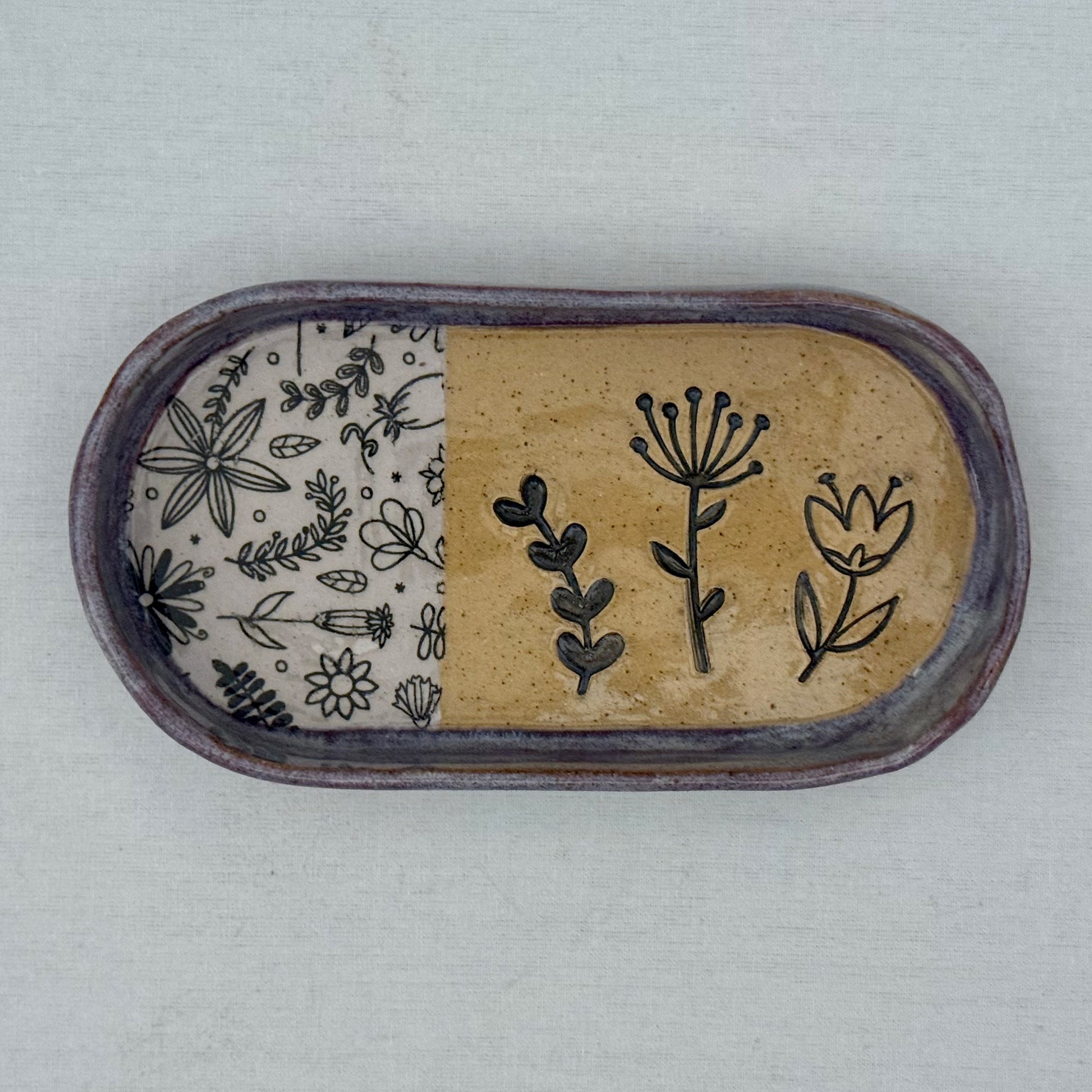 Decorative ceramic tray with floral patterns on a light background