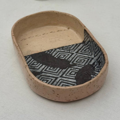 Ceramic dish with geometric pattern on a white background