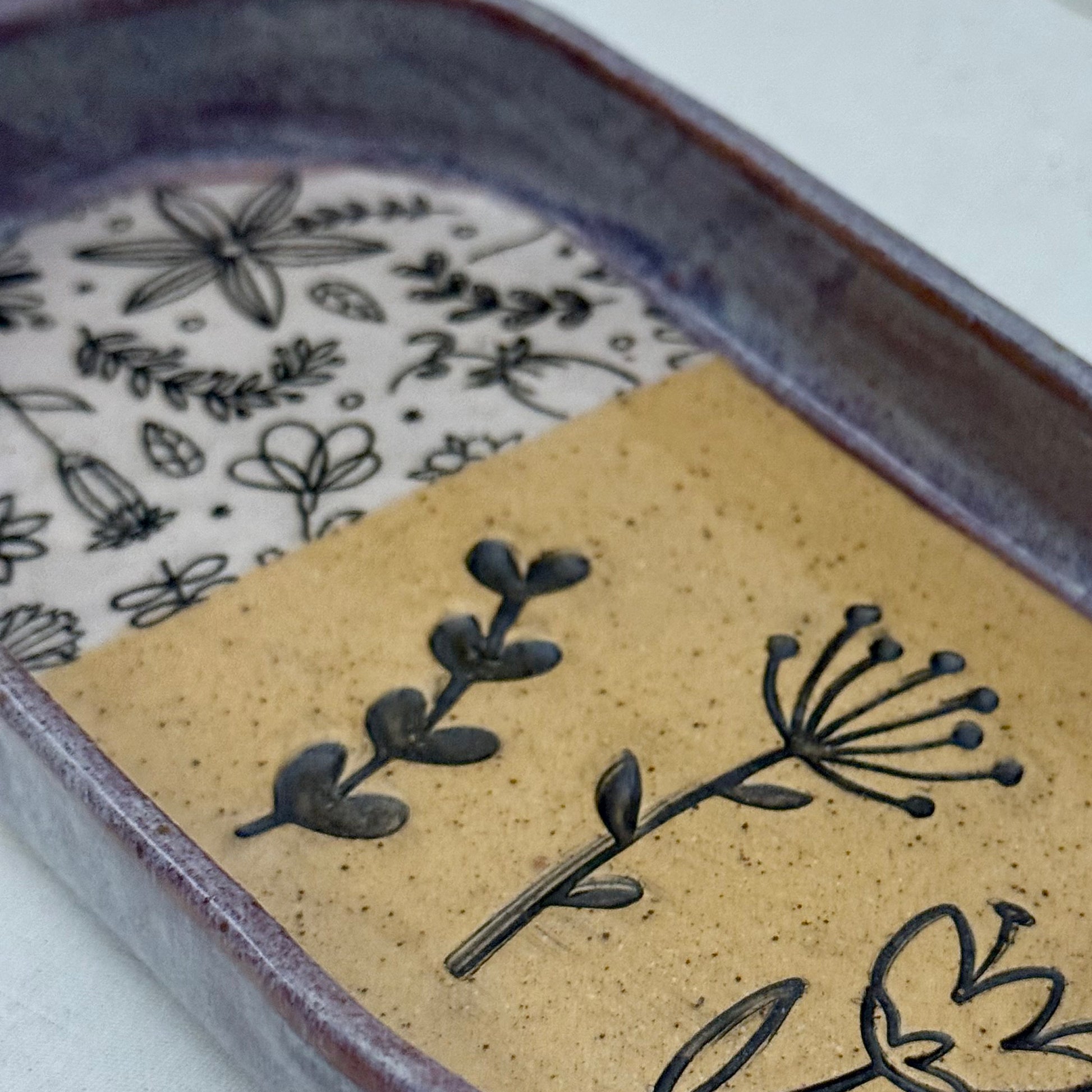 Close-up of a ceramic dish with floral patterns on a white background