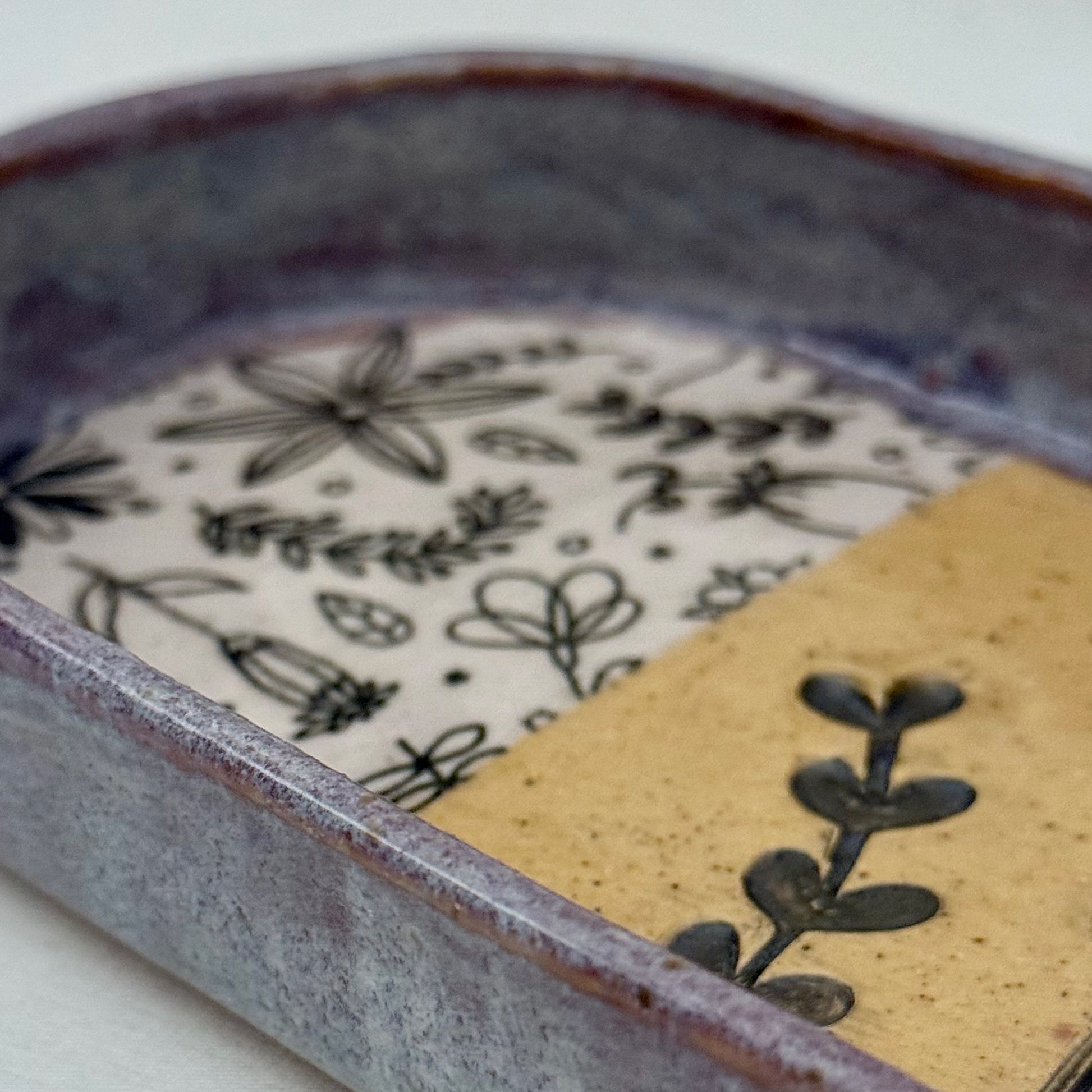 Ceramic dish with floral patterns on a white background