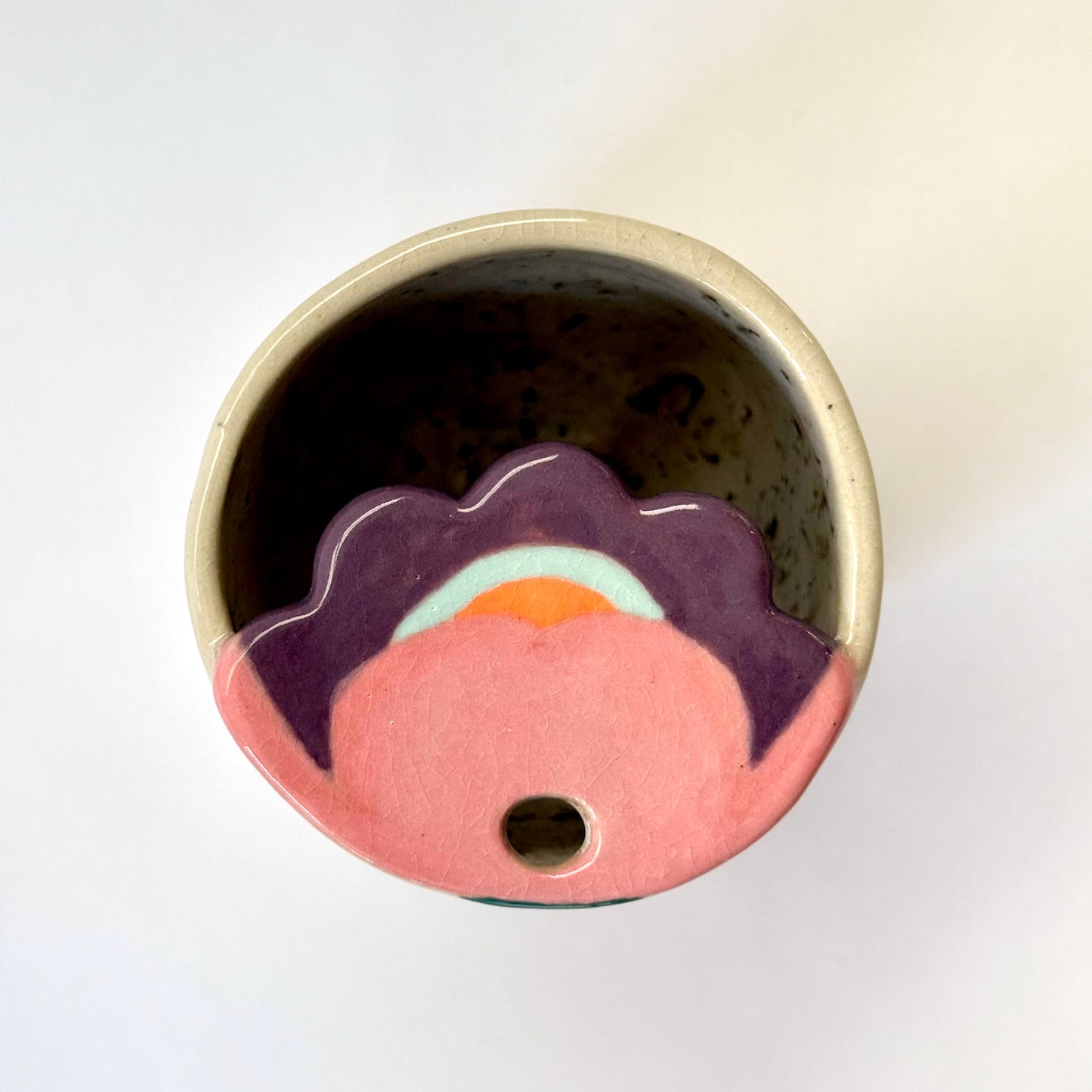 Top view of Ceramic to go mug with floral design on a white background