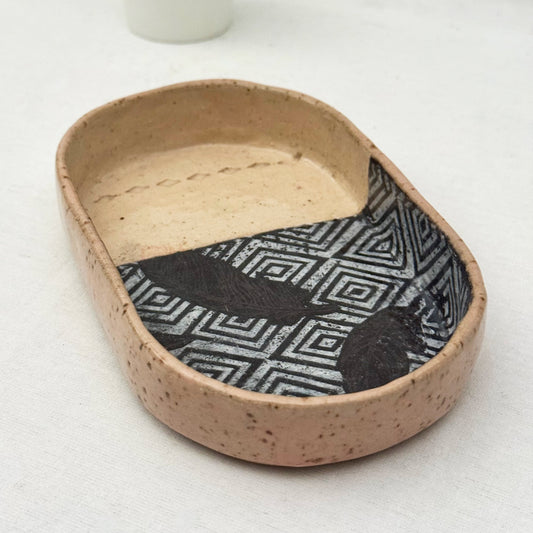 Ceramic dish with geometric pattern on a white background