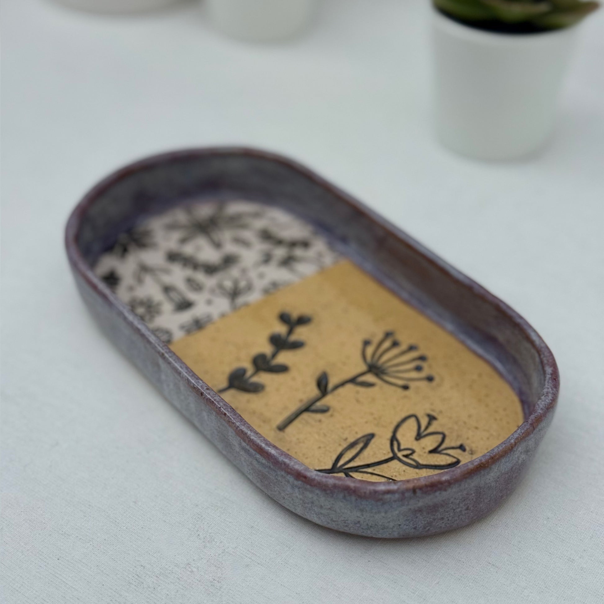 Ceramic tray with floral design on a white surface