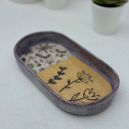 Ceramic tray with floral design on a white surface
