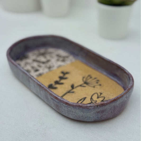 Ceramic tray with floral design on a white surface
