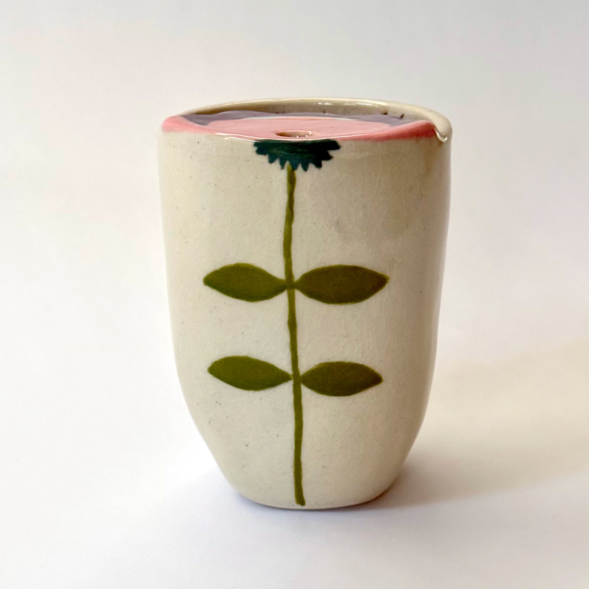 Ceramic to go mug with floral design on a white background